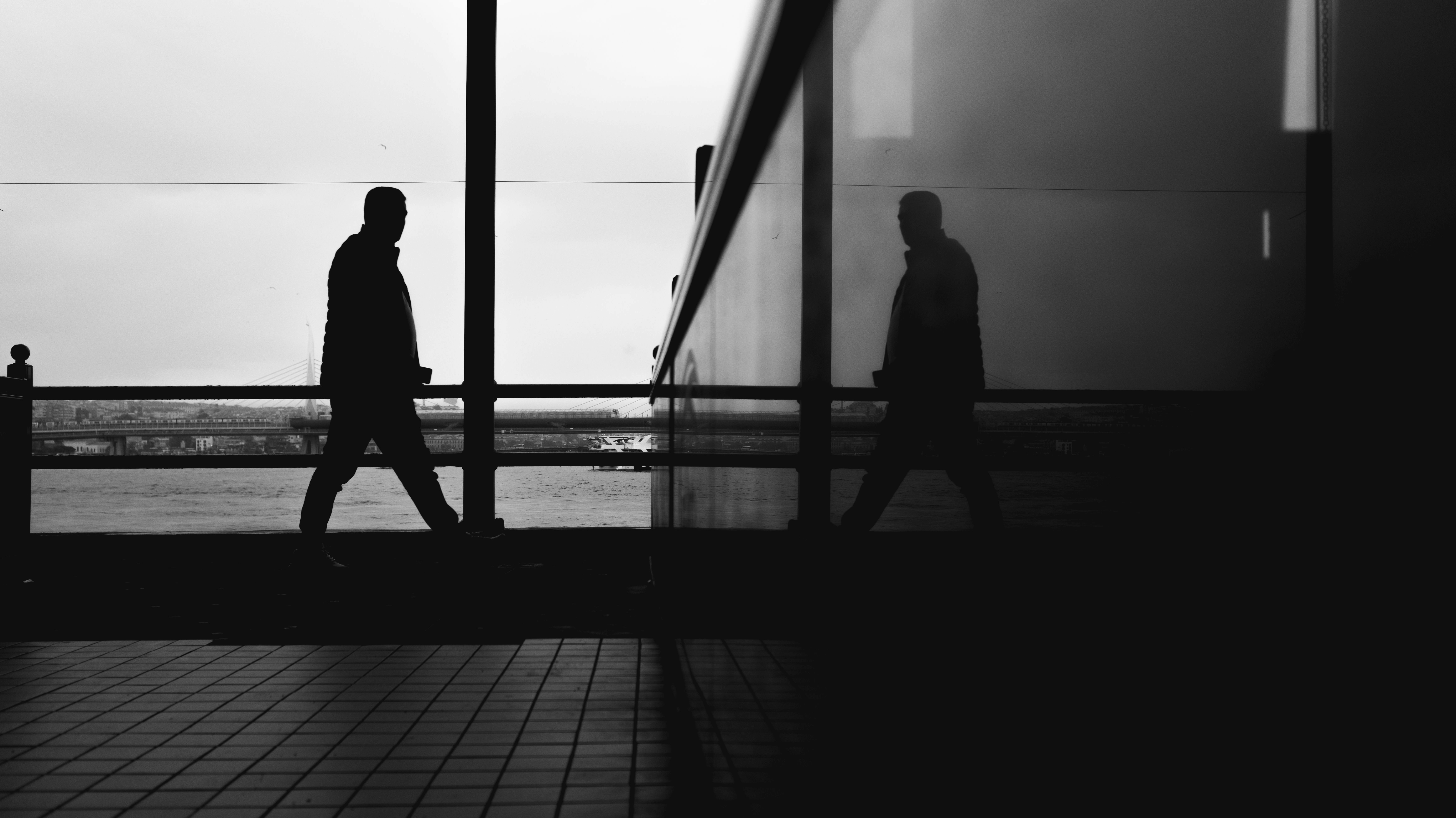 Silhouetted figure standing in a blue-lit data centre, reflecting the human stakes of the AI race.